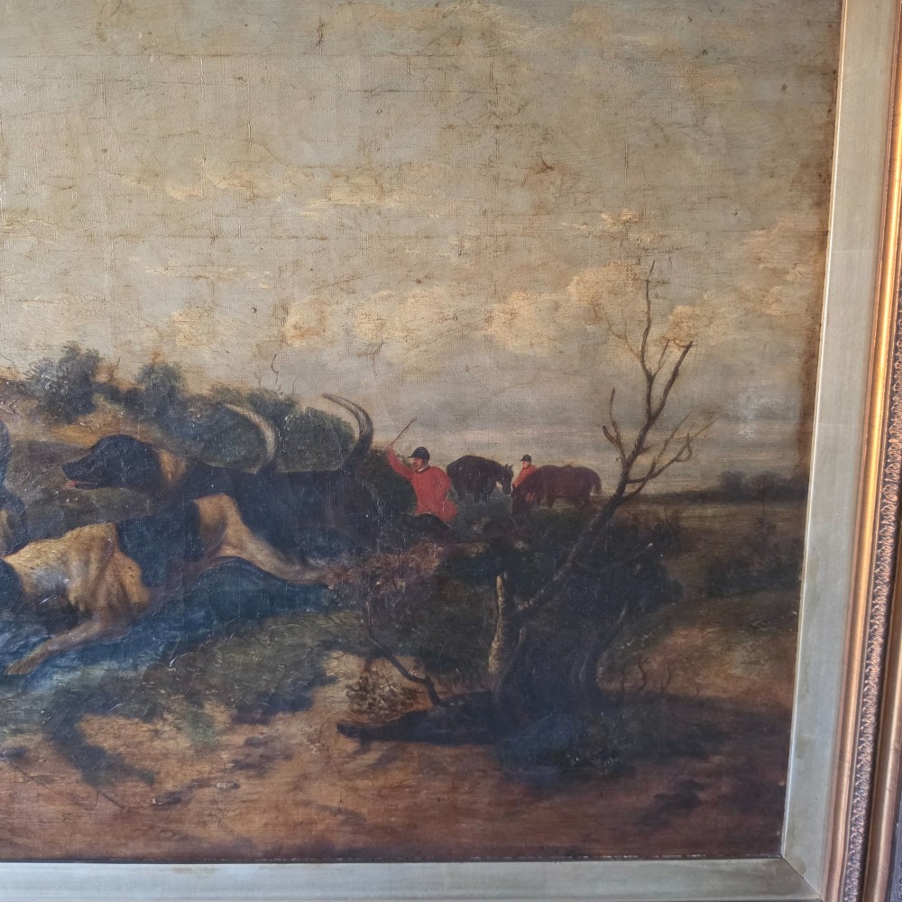 A 19th-century horizontal oil painting on canvas depicting a pack of hunting hounds in a rural landscape, set within an ornate carved gilt frame. View IX