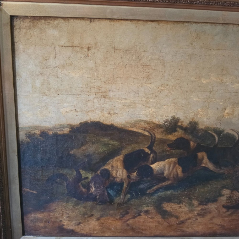 A 19th-century horizontal oil painting on canvas depicting a pack of hunting hounds in a rural landscape, set within an ornate carved gilt frame. View X
