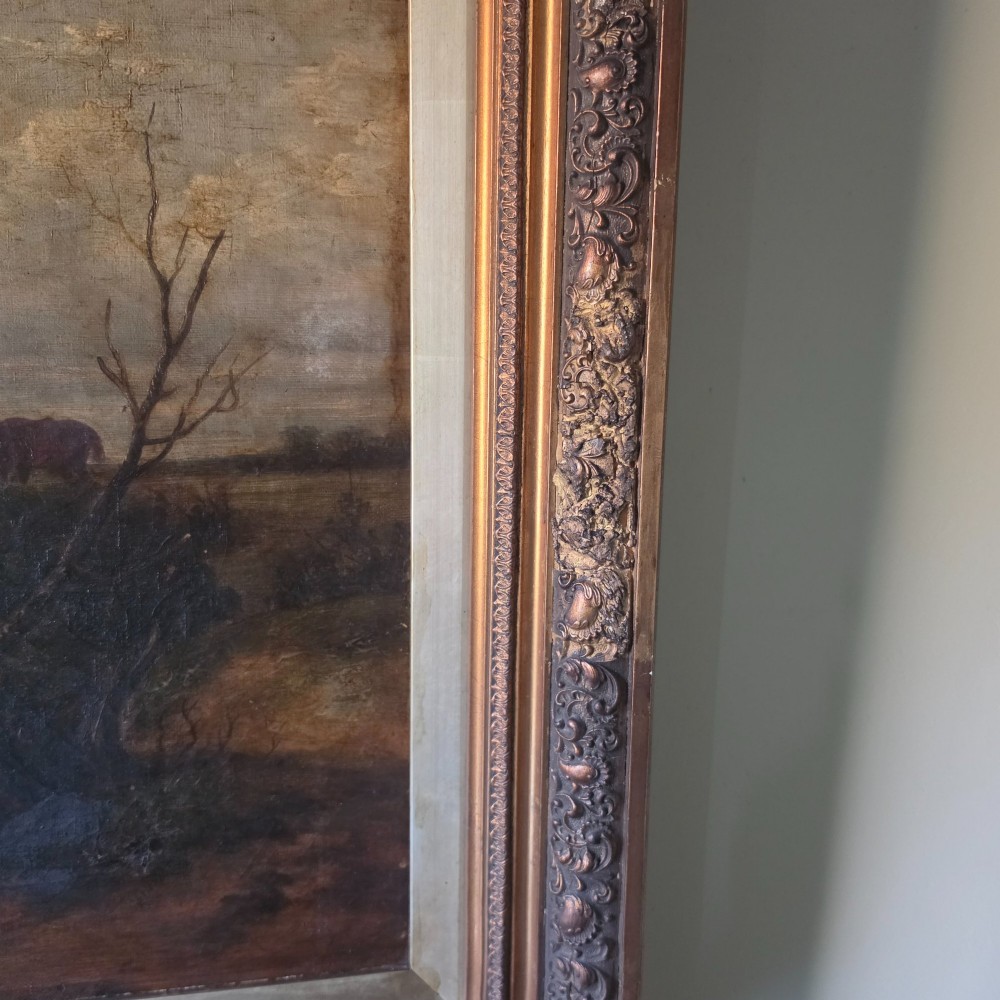 A 19th-century horizontal oil painting on canvas depicting a pack of hunting hounds in a rural landscape, set within an ornate carved gilt frame. View XII