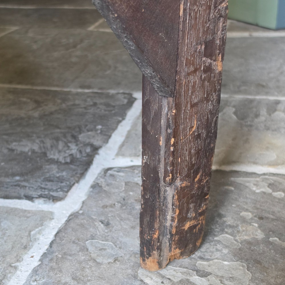 A 17th century dark oak food hutch with carved diamond lozenge doors and turned front legs. View XII