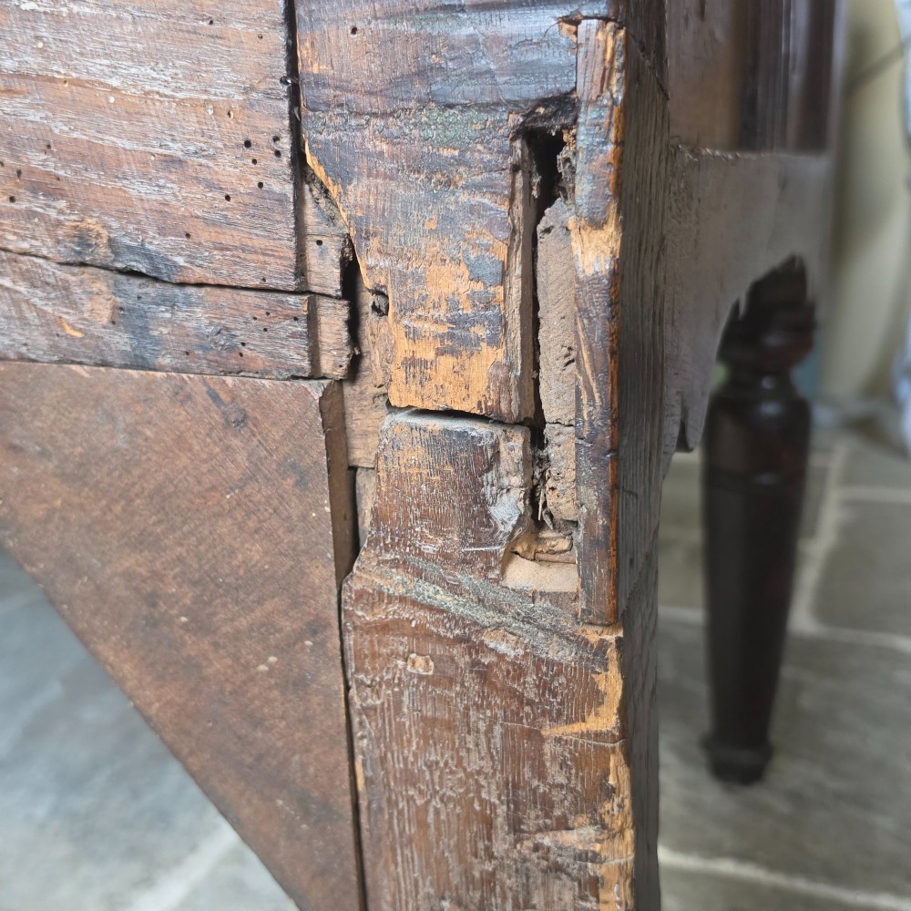 A 17th century dark oak food hutch with carved diamond lozenge doors and turned front legs. View XIV