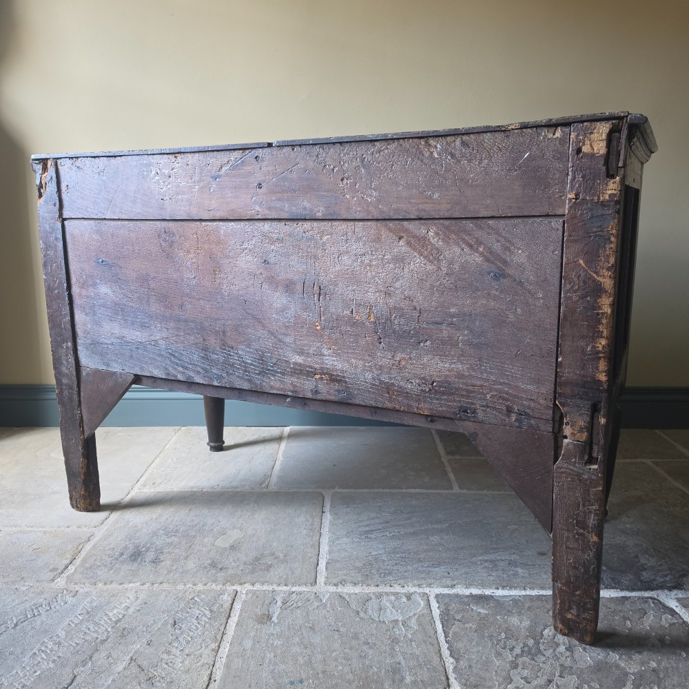 A 17th century dark oak food hutch with carved diamond lozenge doors and turned front legs. View XV