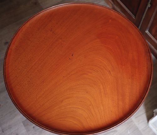 A mahogany tilt-top tripod table featuring a circular dished top, turned central column, and three cabriole legs. View III