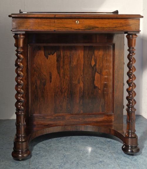 fig 1. A Victorian rosewood Davenport desk featuring barley twist front supports, side drawers with wooden knob handles, and a hinged slanted top.