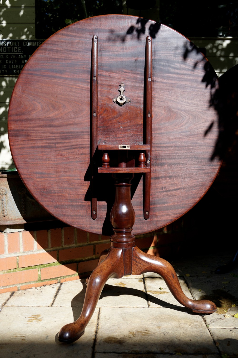 A Georgian mahogany tripod table featuring a circular top, turned central column, and three cabriole legs ending in pad feet. View IV