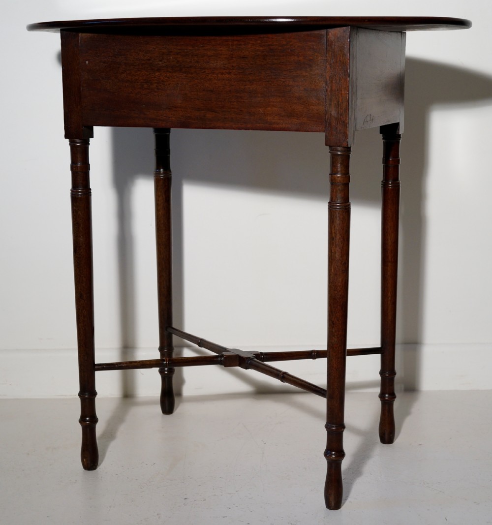 Oval mahogany table supported on four turned tapering legs braced by turned under frame retaining original lion mask View III