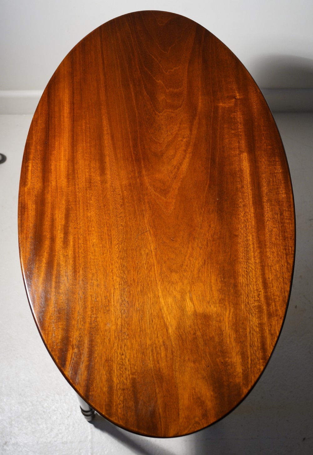 Oval mahogany table supported on four turned tapering legs braced by turned under frame retaining original lion mask View IV