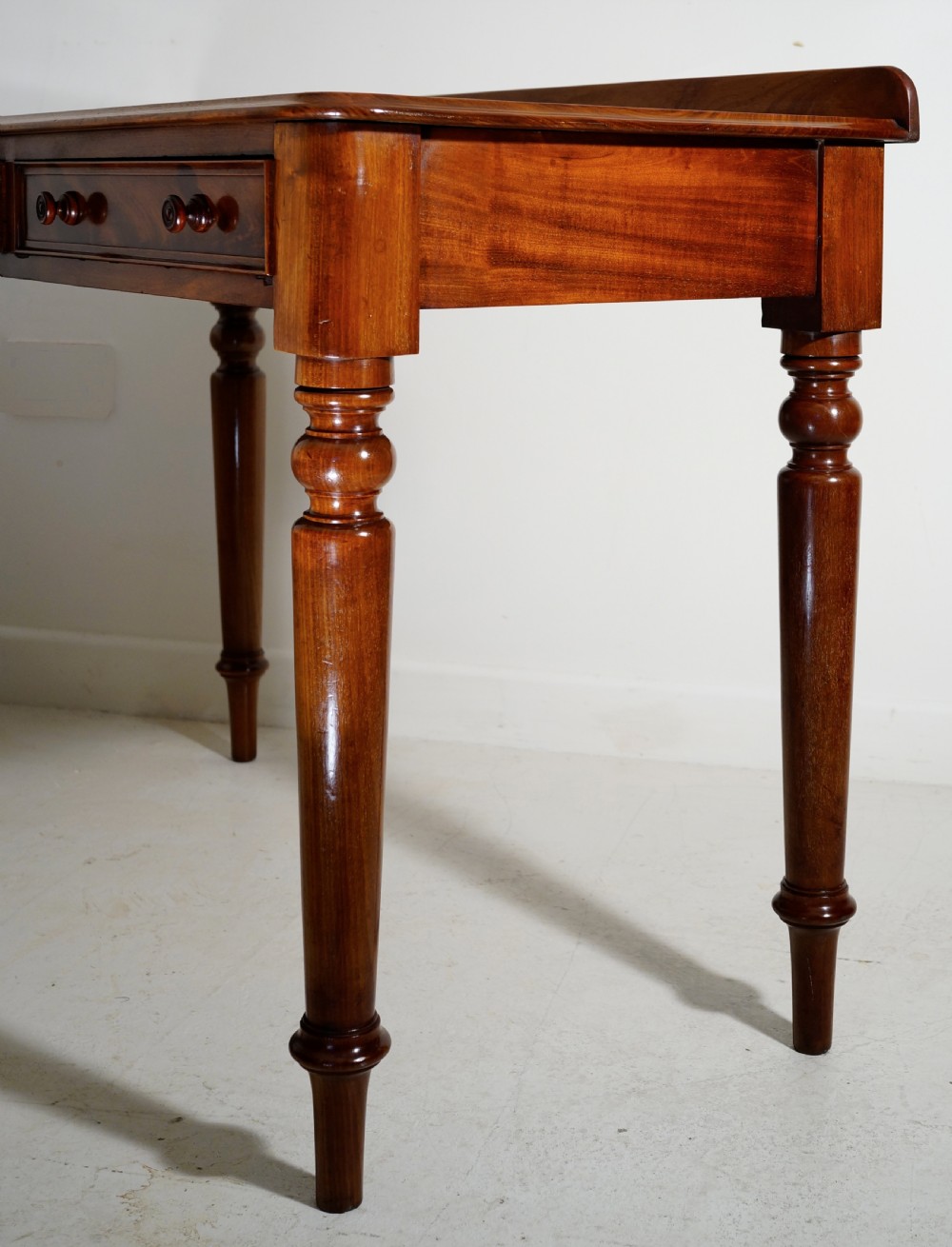 Victorian 1860s mahogany table with two drawers supported on four turned tapering legs. View II