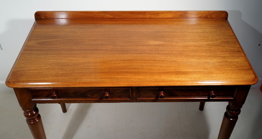 Victorian 1860s mahogany table with two drawers supported on four turned tapering legs. View IV