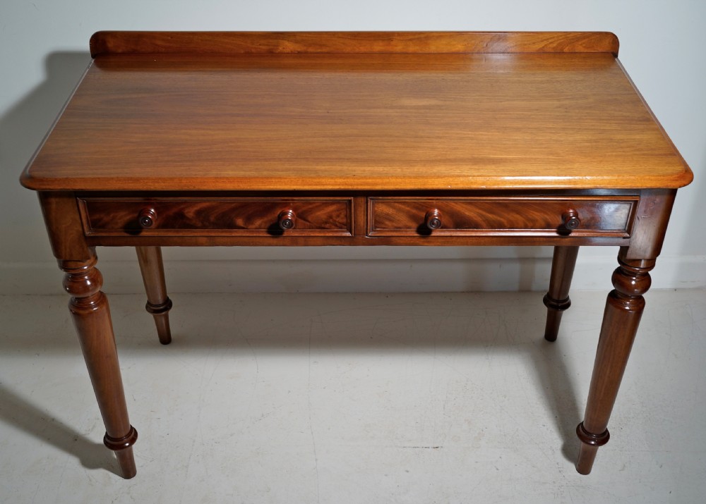 Victorian 1860s mahogany table with two drawers supported on four turned tapering legs. View V