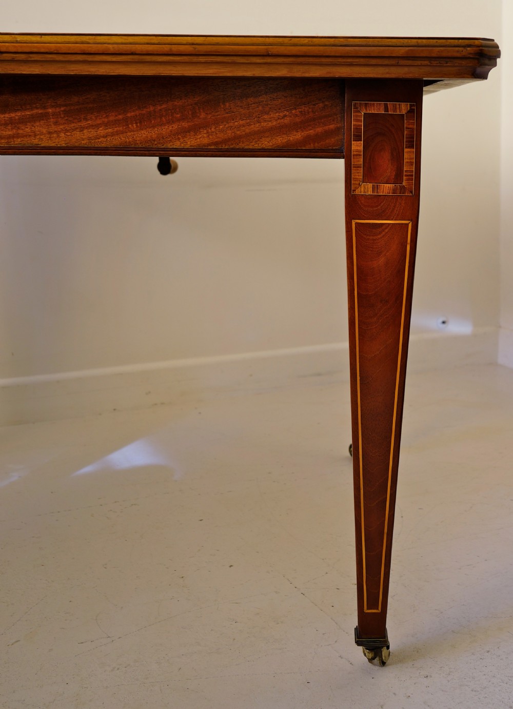 1900s extending wind-out mahogany inlaid dining table on square tapering legs. View III