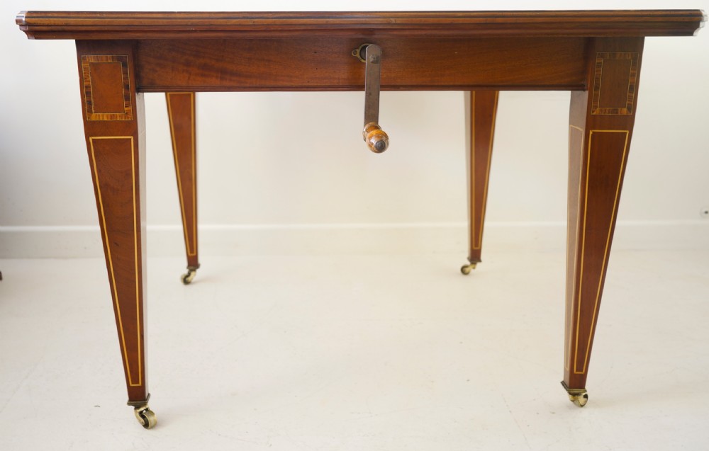 1900s extending wind-out mahogany inlaid dining table on square tapering legs. View IV