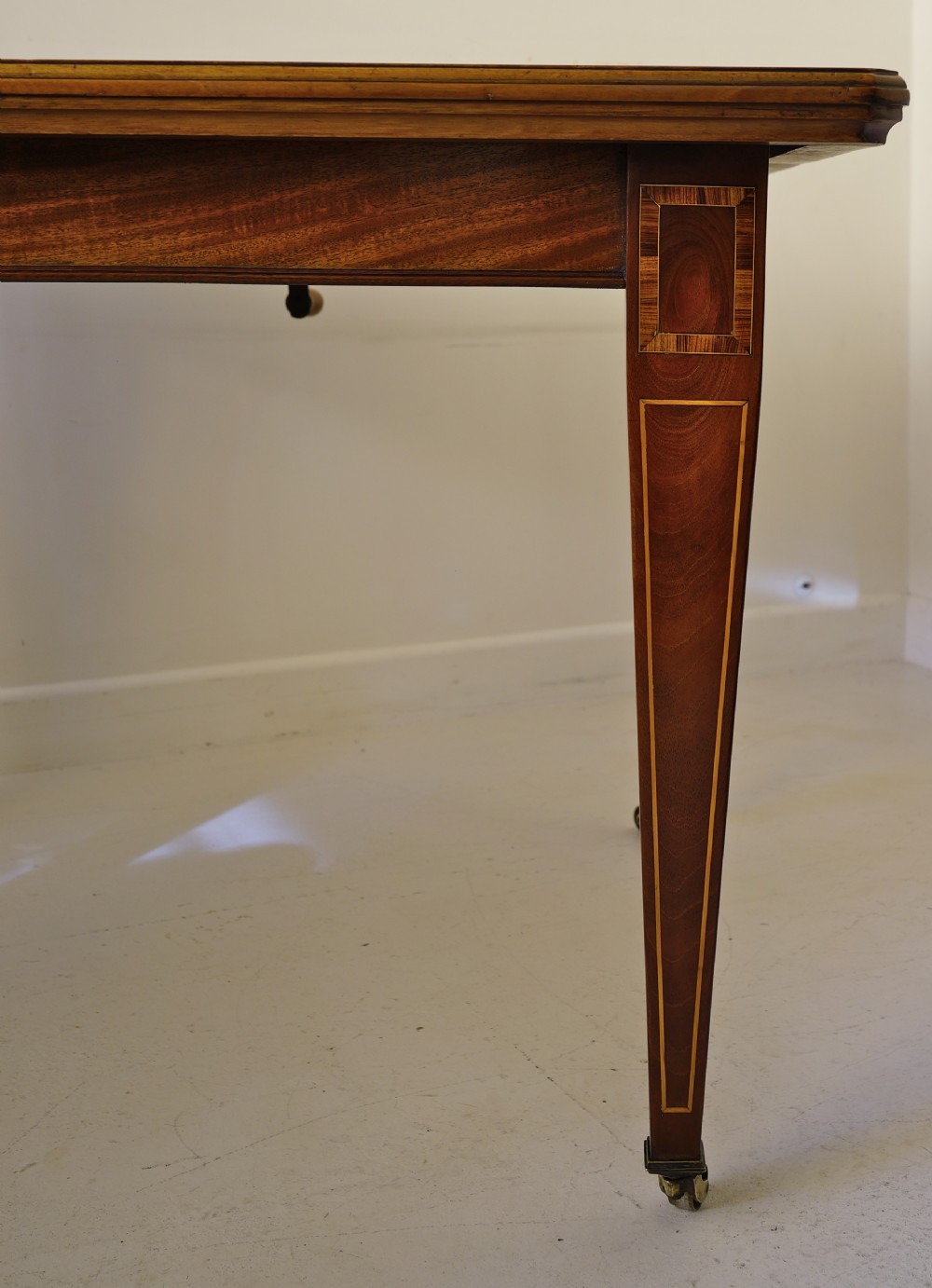 1900s extending wind-out mahogany inlaid dining table on square tapering legs. View V