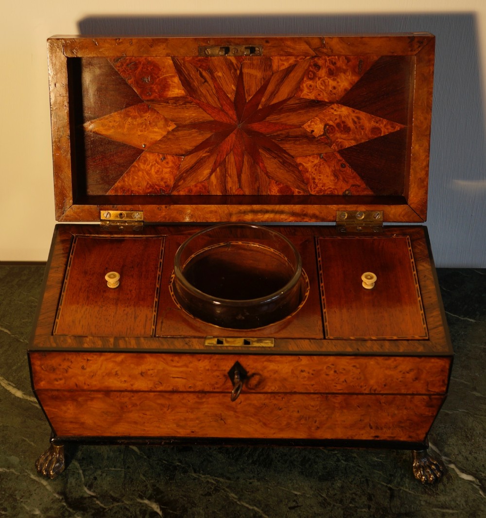 A fine 1820s Pollard oak and inlaid tea caddy supported