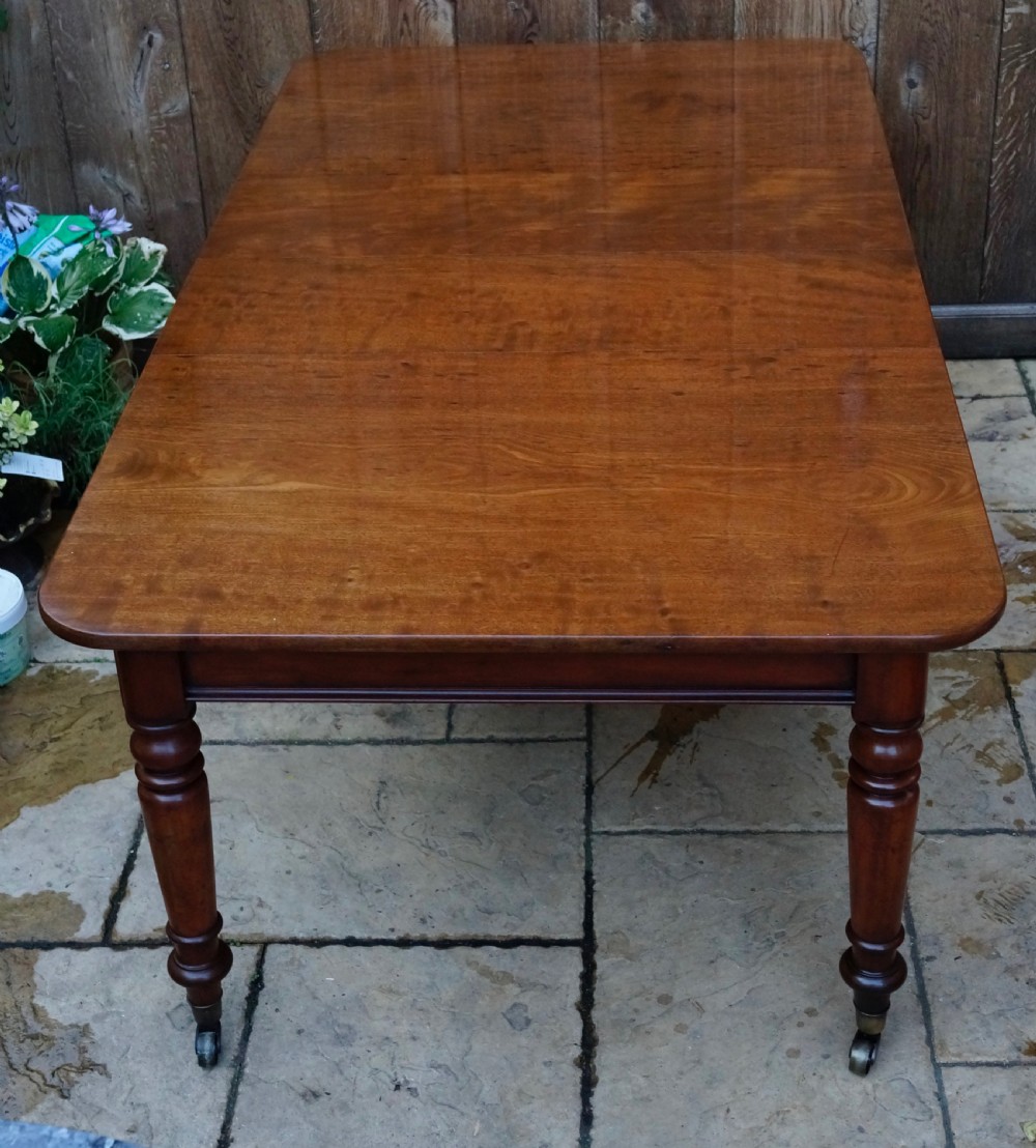 Solid Mahogany extending dining table. View IV