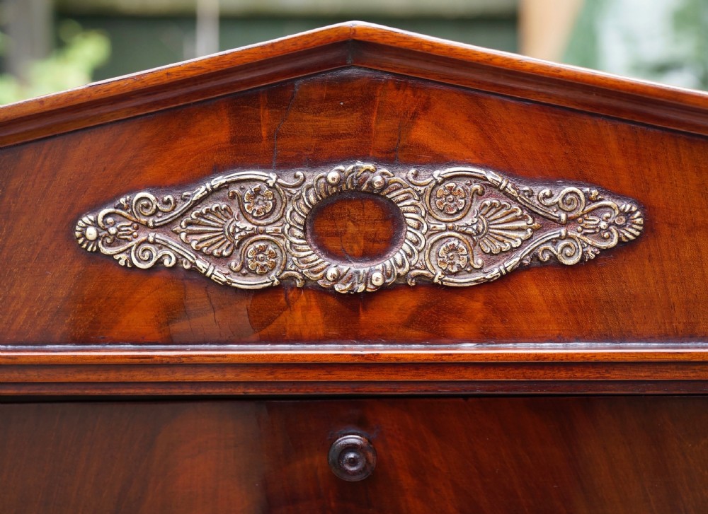 A Victorian mahogany swing dressing mirror featuring a pediment top decorated with a brass mount, side columns, and a single drawer base. View VII