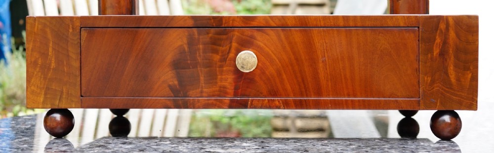 A Victorian mahogany swing dressing mirror featuring a pediment top decorated with a brass mount, side columns, and a single drawer base. View VIII
