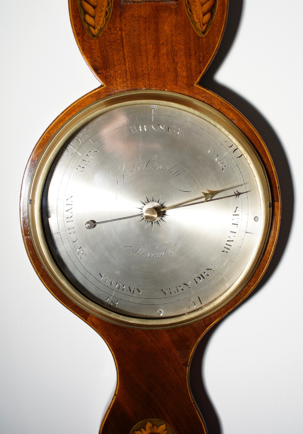 An antique 1830s William IV mahogany banjo barometer featuring shell marquetry inlays, a central thermometer, and a round silvered dial. View III