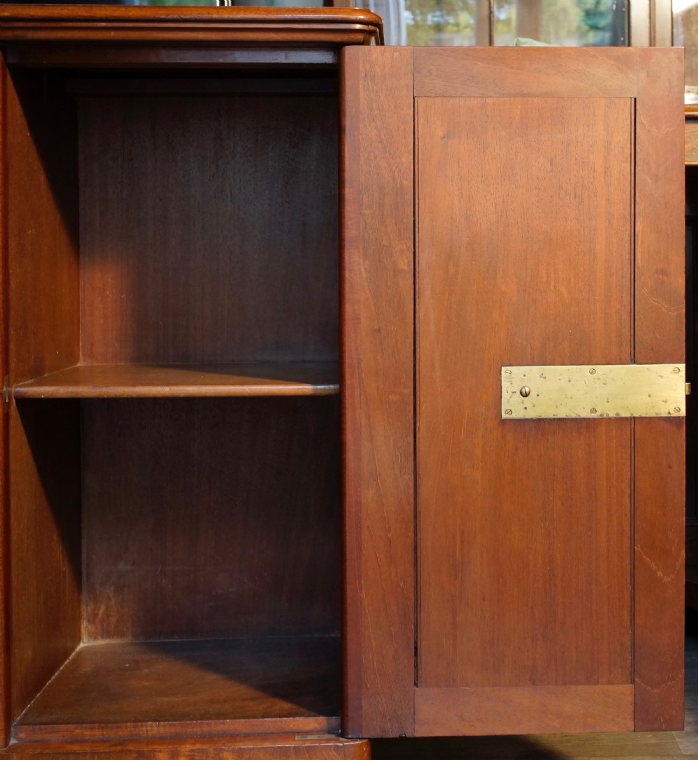 An antique warm brown mahogany single-door cupboard featuring a central turned circular catch, side column mouldings, and a solid plinth base. View VI