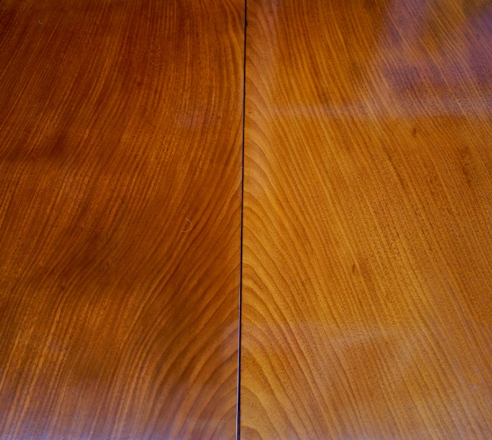 An eighteenth-century mahogany drop leaf table with a polished rectangular top, turned legs, and hand-carved claw and ball feet. View VI