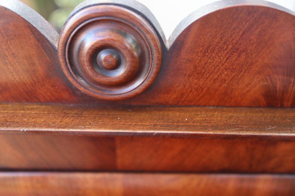 An antique mahogany tabletop toilet mirror featuring an adjustable swivel glass frame supported by turned columns over a two-drawer serpentine base. View VII