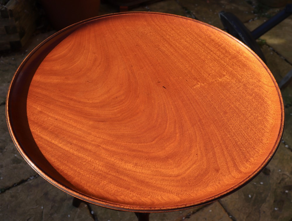 A polished mahogany tripod table with a circular top, turned central column, and three curved legs. View VIII