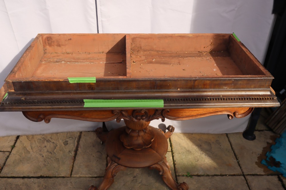 An antique Georgian mahogany cabinet cornice featuring carved dentil moulding and internal timber partition sections.