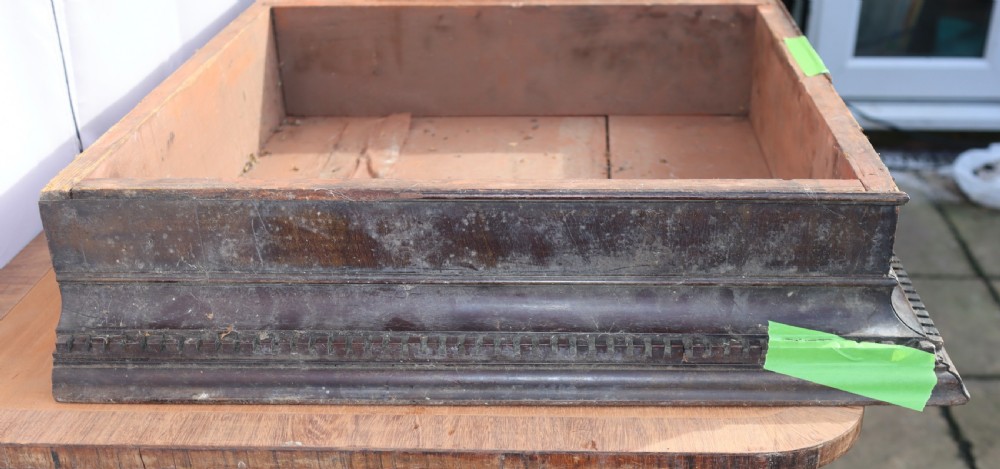 An antique Georgian mahogany cabinet cornice featuring carved dentil moulding and internal timber partition sections. View III