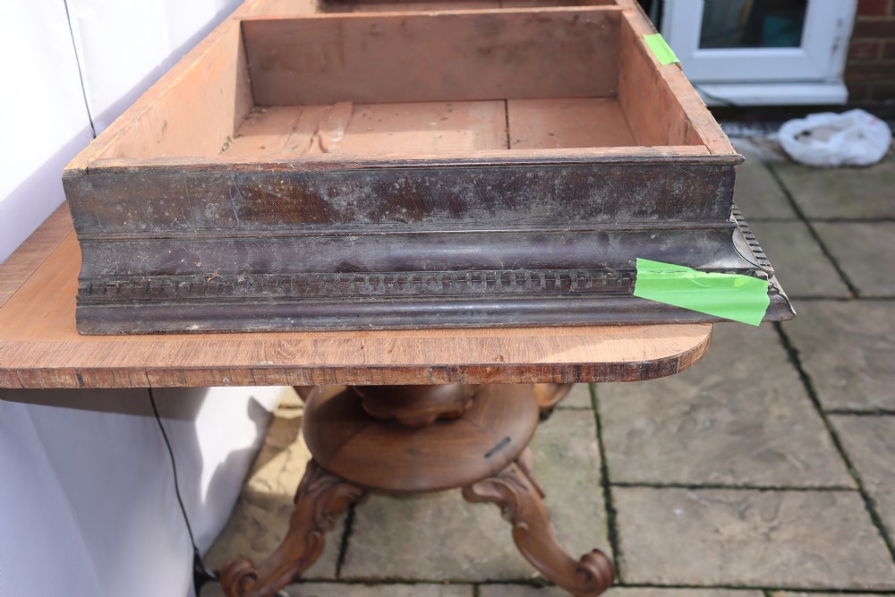 An antique Georgian mahogany cabinet cornice featuring carved dentil moulding and internal timber partition sections. View IV