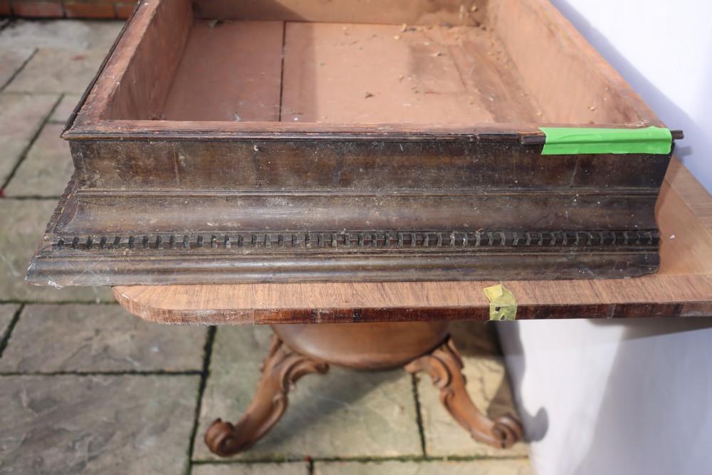 An antique Georgian mahogany cabinet cornice featuring carved dentil moulding and internal timber partition sections. View V