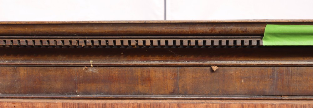 An antique Georgian mahogany cabinet cornice featuring carved dentil moulding and internal timber partition sections. View VII