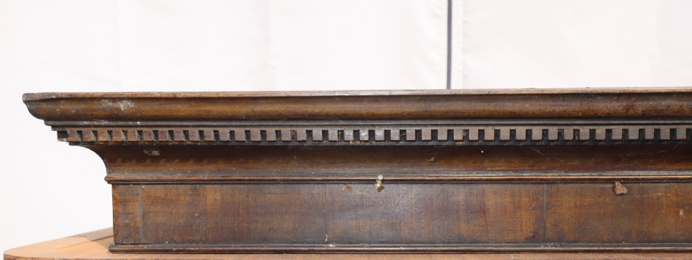 An antique Georgian mahogany cabinet cornice featuring carved dentil moulding and internal timber partition sections. View VIII