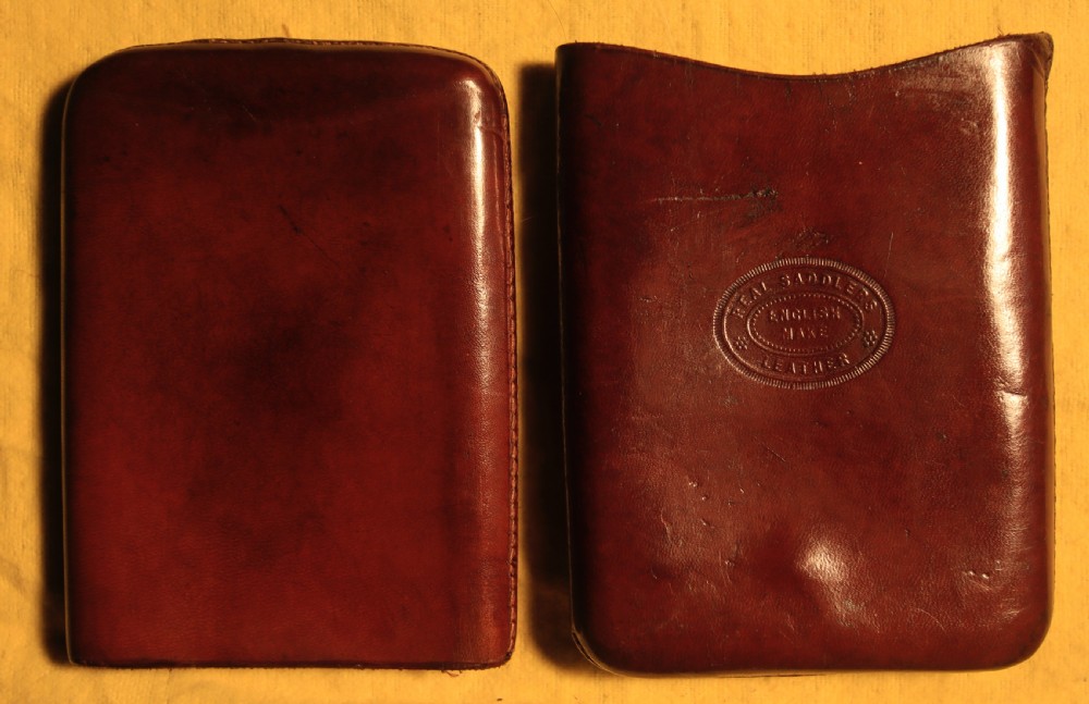 A two-piece chestnut brown saddlers leather cigar case featuring an oval embossed stamp reading Real Saddlers English Make Leather.