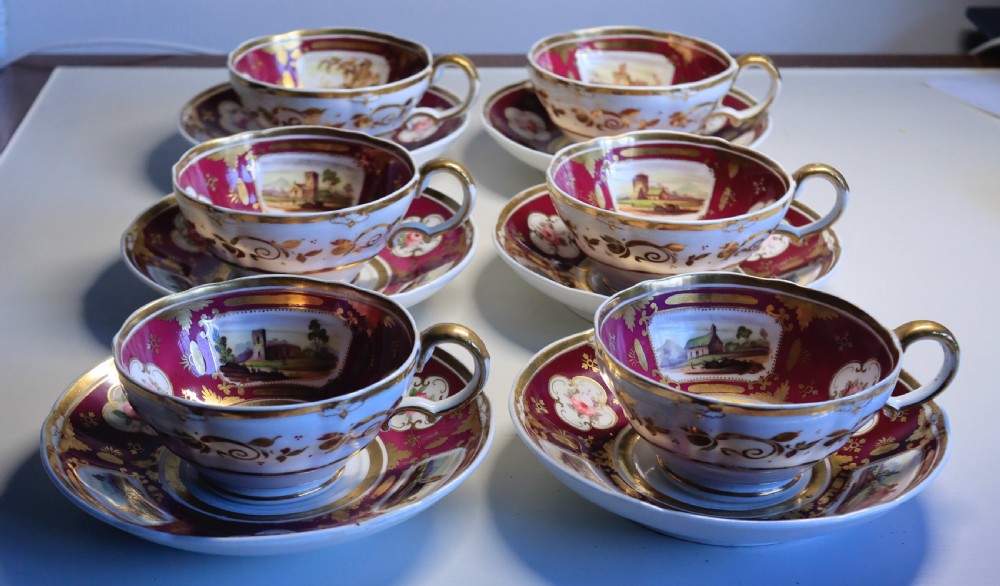An antique Regency-era Hicks, Meigh & Johnson porcelain tea service featuring crimson ground panels, hand-painted landscape scenes, floral vignettes, and heavy gold leaf gilding. View V
