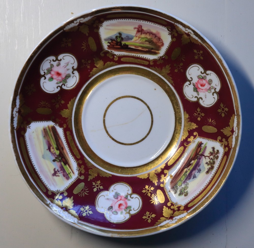 An antique Regency-era Hicks, Meigh & Johnson porcelain tea service featuring crimson ground panels, hand-painted landscape scenes, floral vignettes, and heavy gold leaf gilding. View VIII