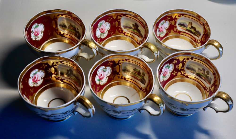 An antique Regency-era Hicks, Meigh & Johnson porcelain tea service featuring crimson ground panels, hand-painted landscape scenes, floral vignettes, and heavy gold leaf gilding. View XIV