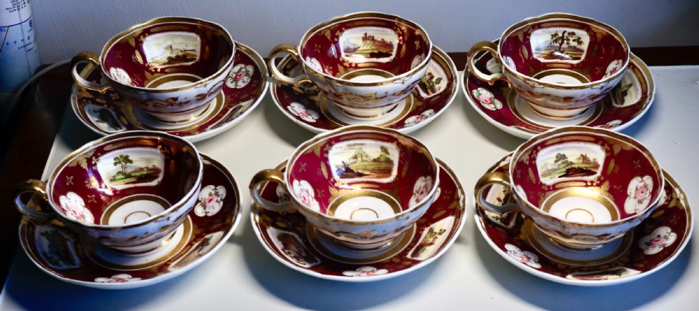 An antique Regency-era Hicks, Meigh & Johnson porcelain tea service featuring crimson ground panels, hand-painted landscape scenes, floral vignettes, and heavy gold leaf gilding. View XVI