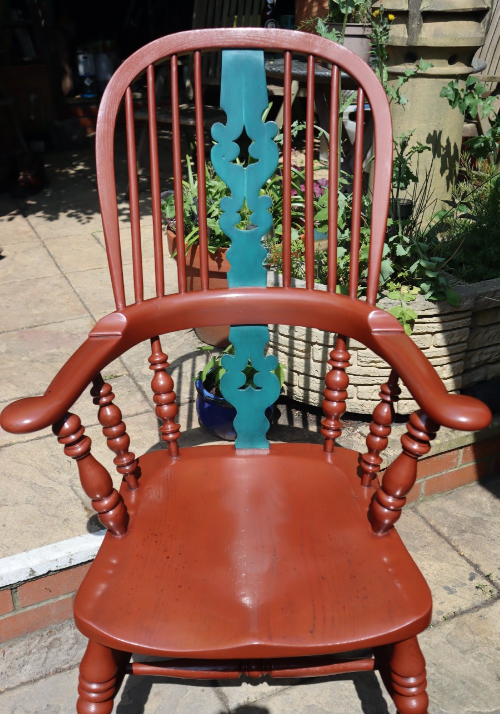 A Victorian hoop-back Windsor armchair painted in terracotta red with a central pierced splat highlighted in teal green. View II