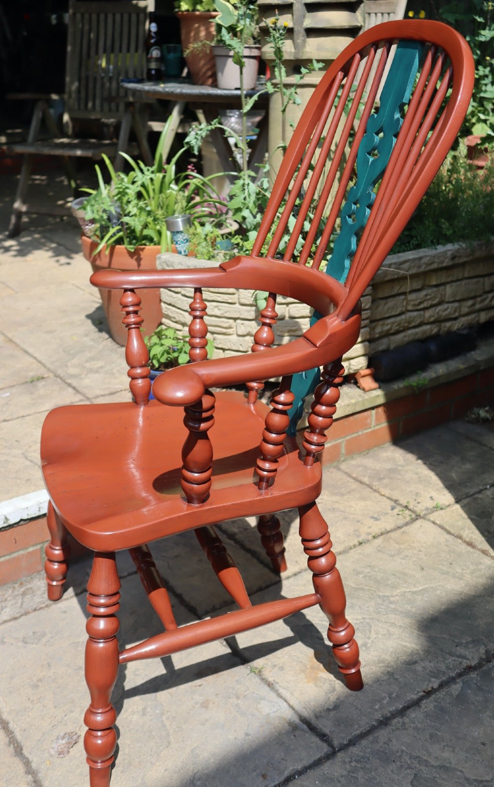 A Victorian hoop-back Windsor armchair painted in terracotta red with a central pierced splat highlighted in teal green. View III