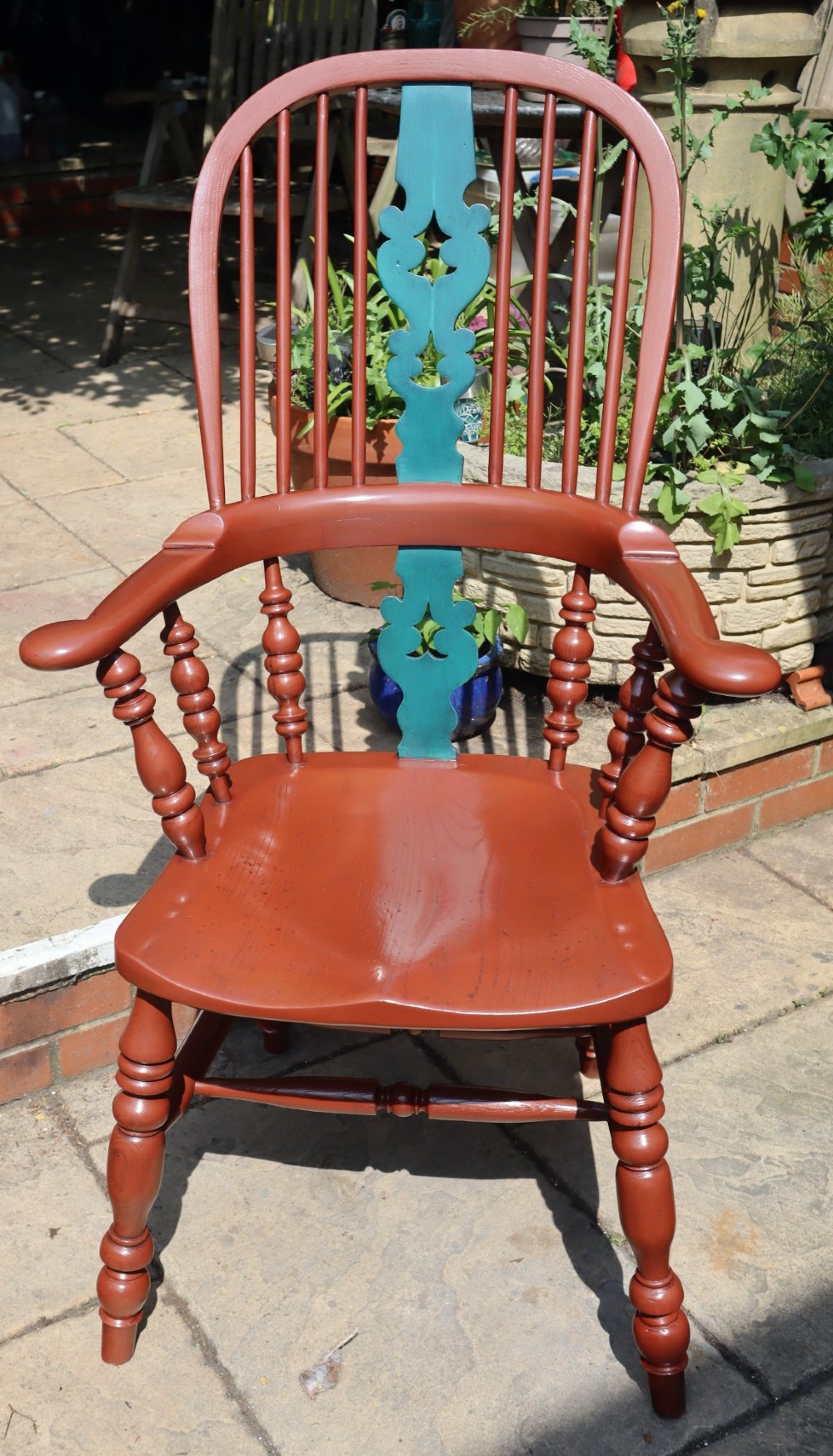 A Victorian hoop-back Windsor armchair painted in terracotta red with a central pierced splat highlighted in teal green. View IV