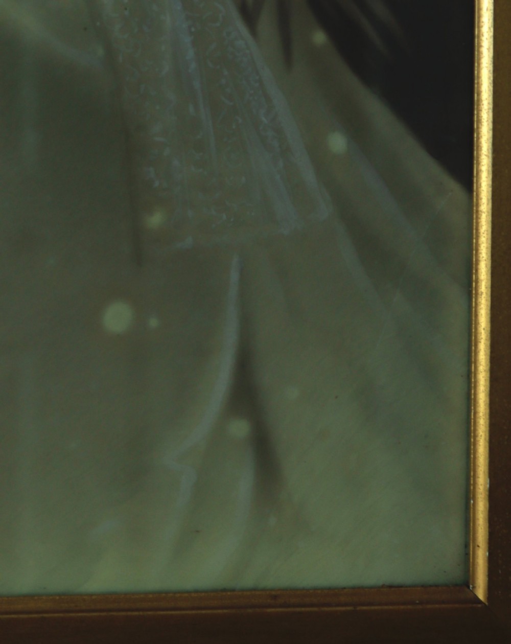 A monochrome Edwardian studio portrait photograph of a seated lady, mounted within a dark polished mahogany frame featuring a gilded inner slip. View XI