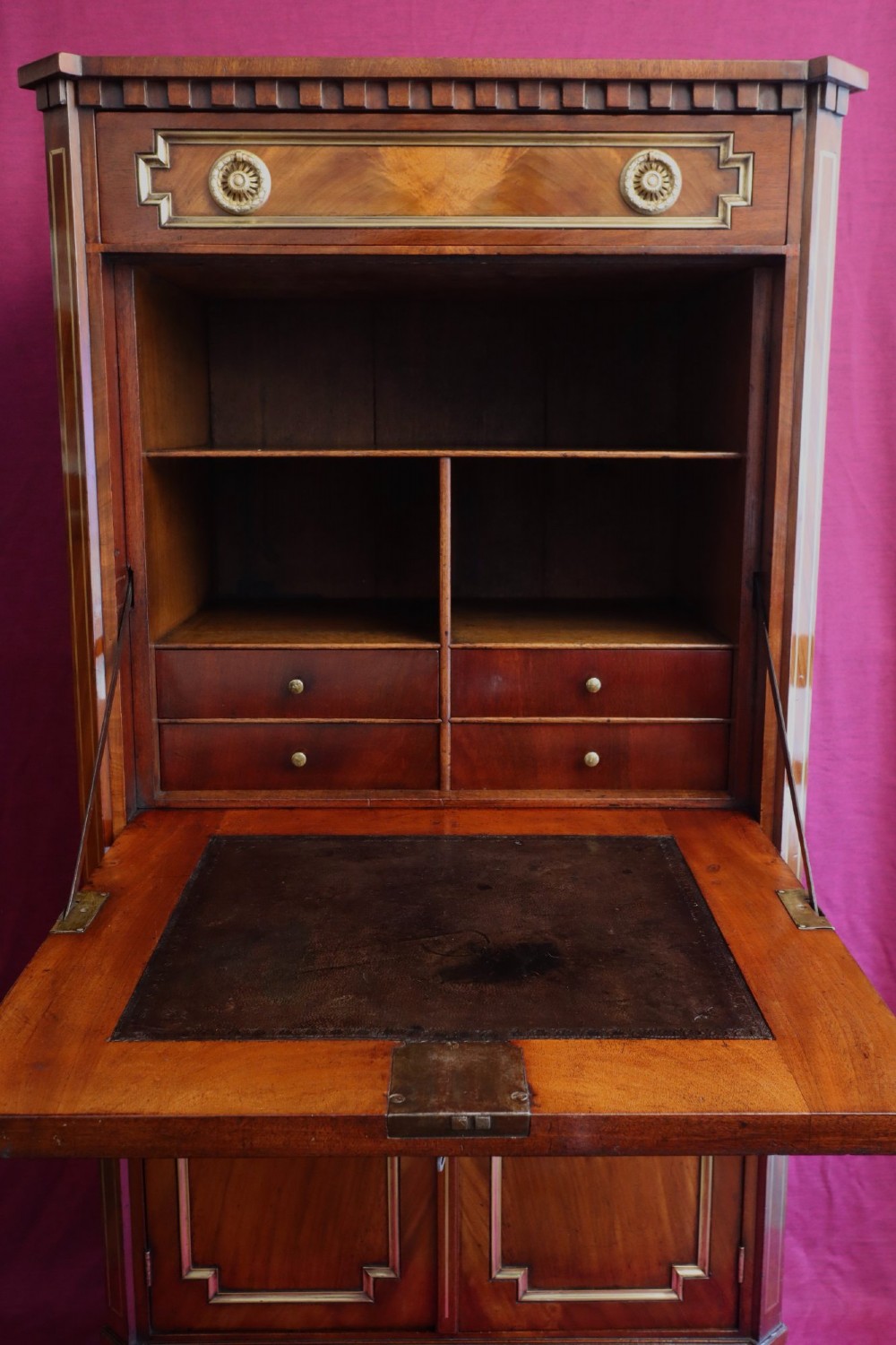 An antique mahogany escritoire featuring brass string inlay, a top drawer, a fall-front writing panel, and a two-door lower cupboard raised on tapered legs. View III