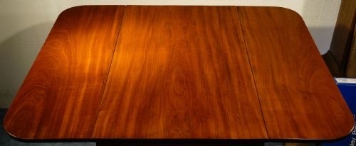 A mahogany Pembroke table featuring two drop leaves, a single frieze drawer with a recessed brass handle, and four turned legs. View III