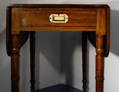A mahogany Pembroke table featuring two drop leaves, a single frieze drawer with a recessed brass handle, and four turned legs. View IV