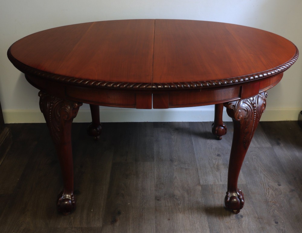 A pair of semi-circular mahogany demilune console tables featuring carved cabriole legs ending in ball and claw feet. View II