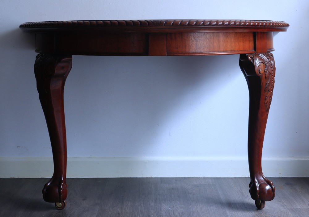 A pair of semi-circular mahogany demilune console tables featuring carved cabriole legs ending in ball and claw feet. View III