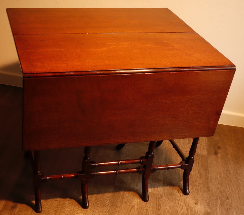 A Georgian mahogany spider leg tea table featuring two hinged drop leaves and slender turned gateleg supports connected by stretchers. View III