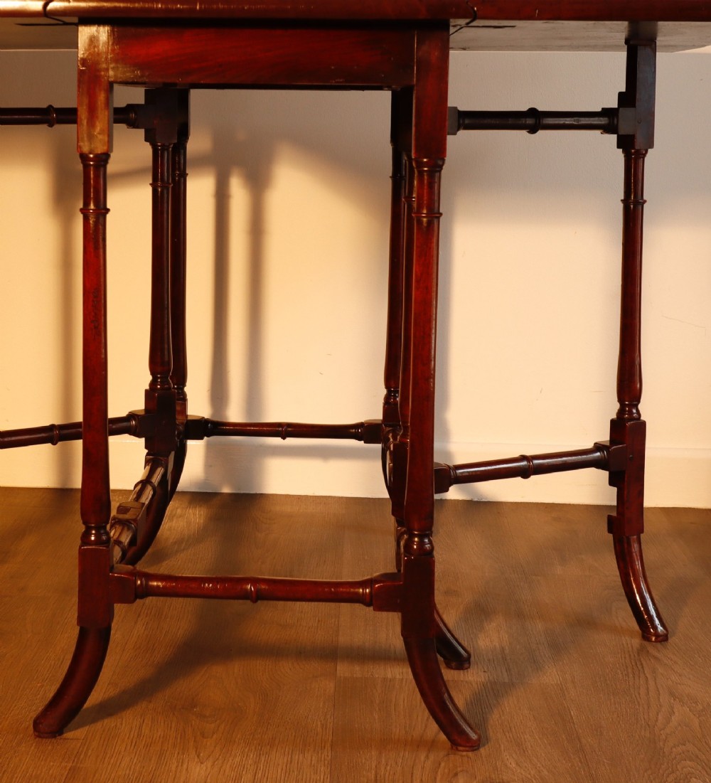 A Georgian mahogany spider leg tea table featuring two hinged drop leaves and slender turned gateleg supports connected by stretchers. View IV