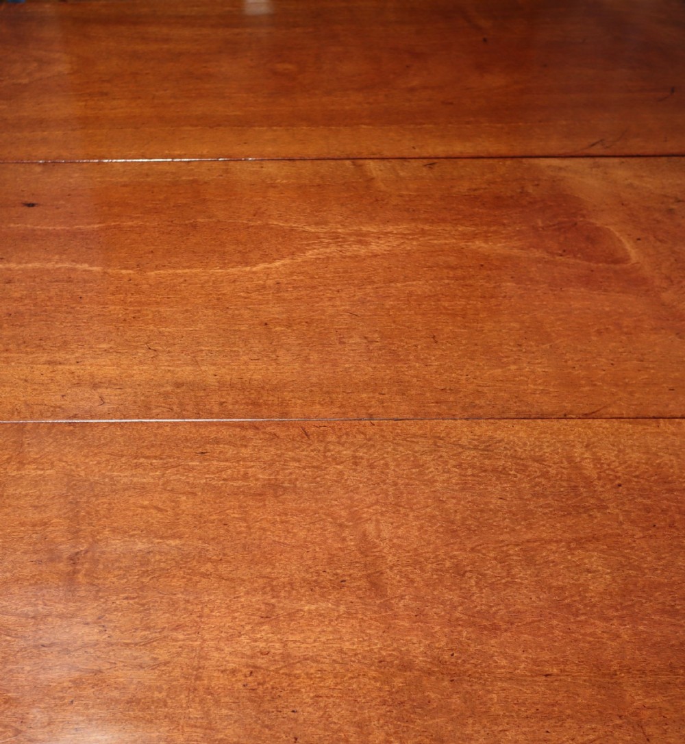 A Georgian mahogany spider leg tea table featuring two hinged drop leaves and slender turned gateleg supports connected by stretchers. View V