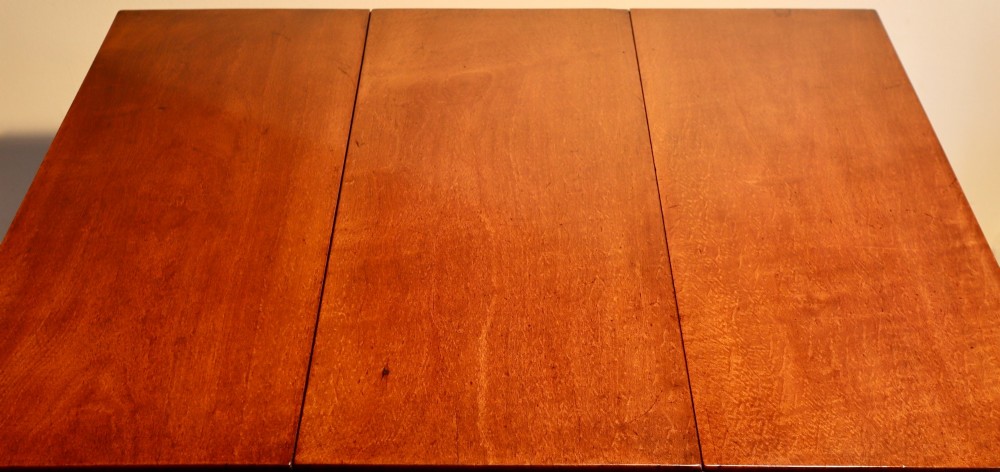 A Georgian mahogany spider leg tea table featuring two hinged drop leaves and slender turned gateleg supports connected by stretchers. View VII